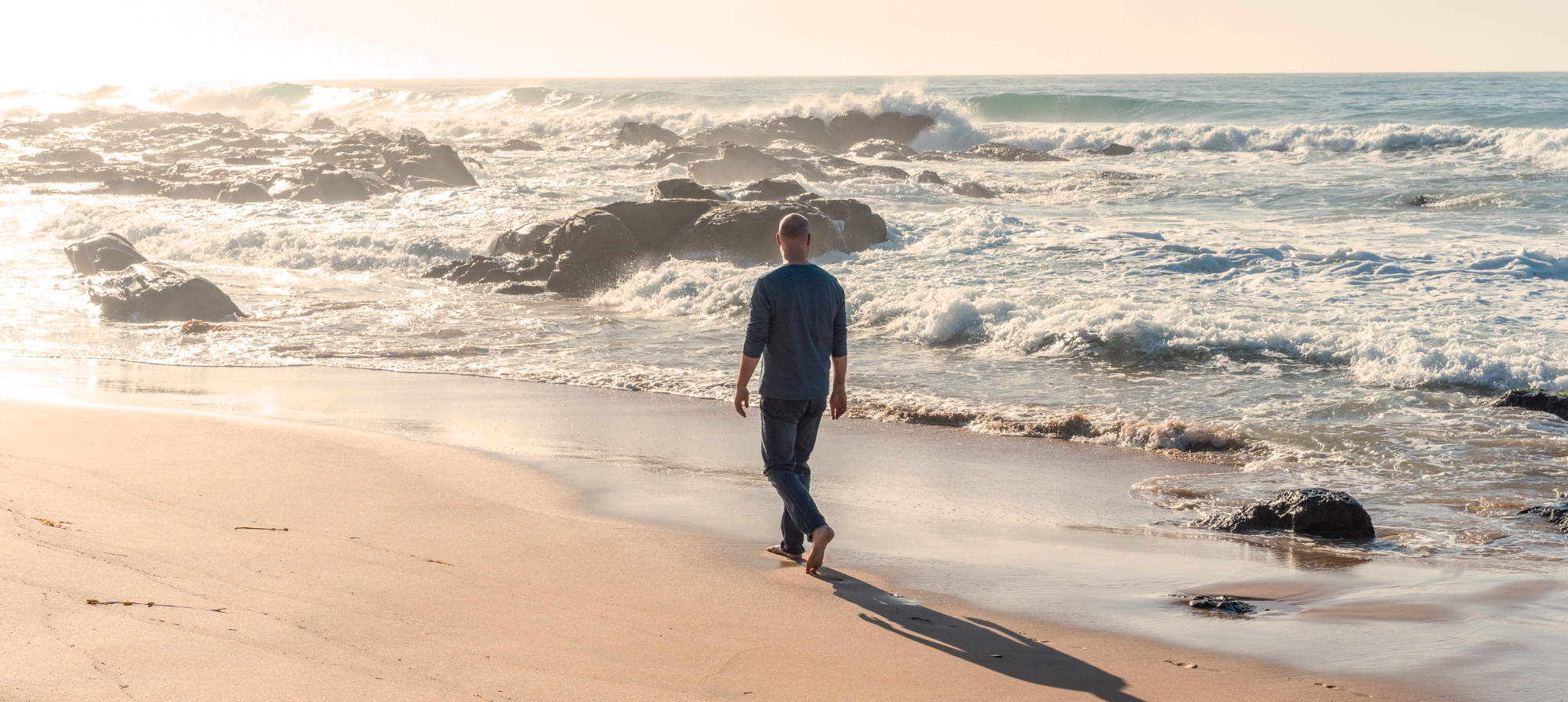 Chris walking on beach